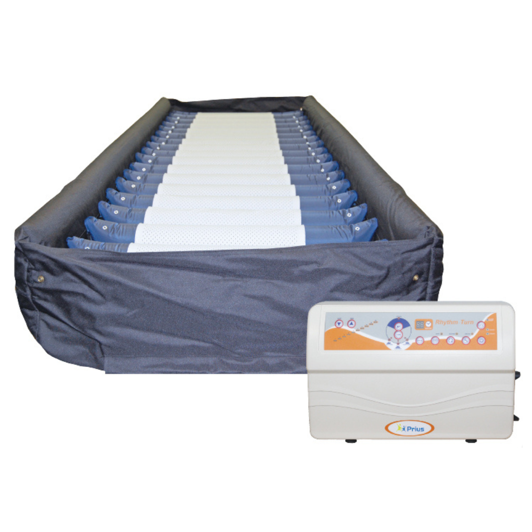 The Prius Rhythm Turn LAL Alternating Pressure Mattress System is designed for medical use, offering lateral rotation therapy with a control unit that displays settings and indicators. The mattresss dark cover ensures True Low Air Loss performance.